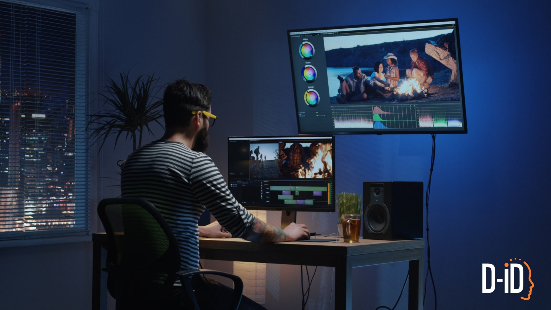 A person sits at a desk editing AI promo videos on two monitors in a dimly lit room at night; the D-ID logo appears in the bottom right corner.