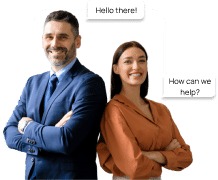 A man in a blue suit and a woman in a brown blouse stand back to back, smiling, with speech bubbles saying, "Hello there!" and "How can we help?"—ready to offer marketing solutions and personalize videos for your business.