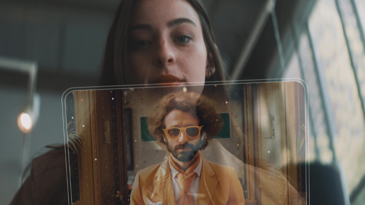 A woman looks at a transparent digital screen displaying a man in a yellow suit and sunglasses, featuring futuristic, holographic visuals powered by Microsoft Azure Avatars.