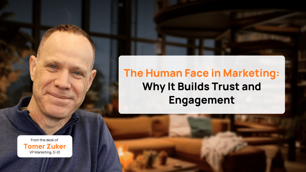 A man sits indoors with a blurred lounge background. A text box reads: “The Human Face in Marketing: Why It Builds Trust and Engagement,” highlighting Tomer Zuker, VP Marketing, D-ID, as he discusses the role of human face avatars in marketing.