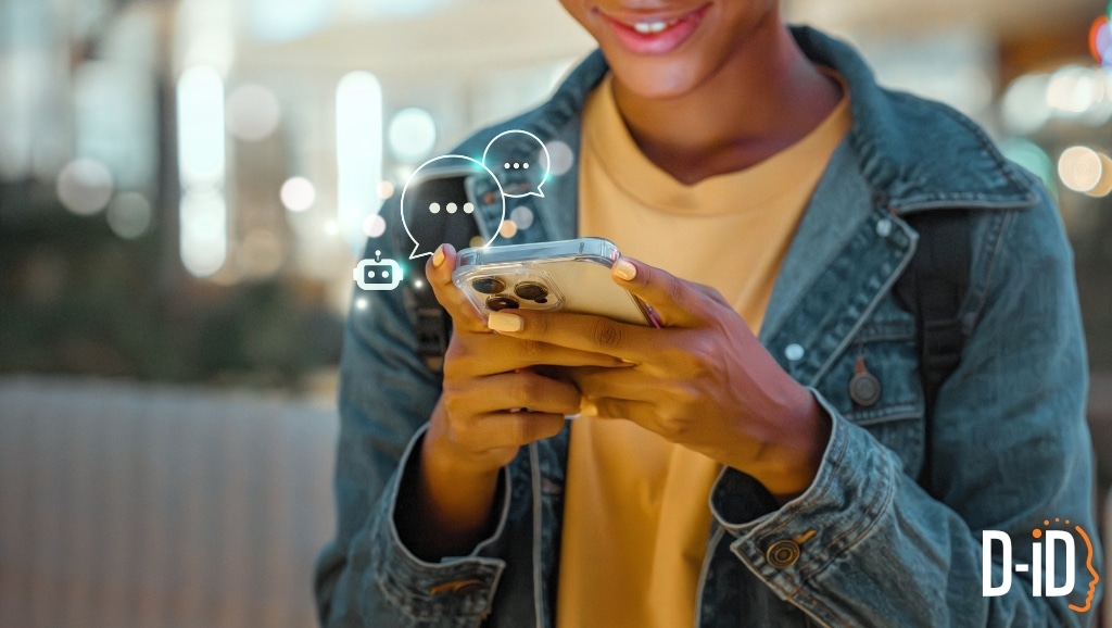 A person in a denim jacket uses a smartphone, with digital chat icons near the phone, suggesting online messaging or interaction powered by conversational AI technology.